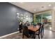 Elegant dining room with dark wood table, leather chairs, and sliding doors to the outdoor area at 12924 W Caraveo Pl, Peoria, AZ 85383
