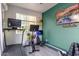 Bright and sunny fitness center with exercise machines and a mounted TV at 12924 W Caraveo Pl, Peoria, AZ 85383