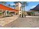 Exterior view of the clubhouse, featuring an inviting entrance, stone accents, and desert landscaping at 12924 W Caraveo Pl, Peoria, AZ 85383