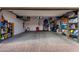 Spacious garage with overhead storage racks and ample room for vehicles and tools at 12924 W Caraveo Pl, Peoria, AZ 85383