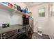 A modern laundry room with gray front-loading appliances and a built in shelf at 12924 W Caraveo Pl, Peoria, AZ 85383