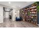 Spacious living area with a large bookcase, comfortable seating, and a view of the entryway at 12924 W Caraveo Pl, Peoria, AZ 85383
