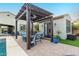 Outdoor living space featuring a covered pergola with a dining set, patio heater, and manicured artificial turf at 12924 W Caraveo Pl, Peoria, AZ 85383