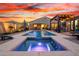 Spacious pool and spa with water features, surrounded by a paved patio and lush landscaping at 12924 W Caraveo Pl, Peoria, AZ 85383