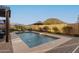 Beautiful pool with fountain features and desert mountain views in the background at 12924 W Caraveo Pl, Peoria, AZ 85383