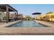 Beautiful backyard pool featuring water fountains, patio umbrellas and a covered pergola with outdoor seating at 12924 W Caraveo Pl, Peoria, AZ 85383