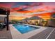 This backyard features a pool with fountains and desert landscaping at 12924 W Caraveo Pl, Peoria, AZ 85383