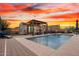 Inviting backyard oasis with a pool, desert landscaping, and a cabana at 12924 W Caraveo Pl, Peoria, AZ 85383