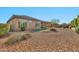 Landscaped backyard featuring gravel, artificial grass, and covered patio area at 1320 W Whitman Dr, Anthem, AZ 85086