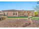 Spacious backyard with gravel landscaping, artificial turf, and covered patio at 1320 W Whitman Dr, Anthem, AZ 85086