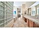 Hall bathroom with a tile floor, glass block wall, and a tub/shower at 1320 W Whitman Dr, Anthem, AZ 85086