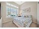 Bright bedroom featuring large windows with shutter blinds and patterned bedding at 1320 W Whitman Dr, Anthem, AZ 85086
