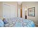 Bedroom with a double closet and a queen bed with patterned bedding at 1320 W Whitman Dr, Anthem, AZ 85086