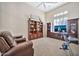 Bedroom featuring a book case, entertainment center with television, and a comfortable armchair at 1320 W Whitman Dr, Anthem, AZ 85086