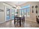 Cozy dining area with a square table and chairs by a window and sliding glass doors at 1320 W Whitman Dr, Anthem, AZ 85086