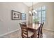 Cozy dining room featuring stylish light fixture, tile floors and a bright window at 1320 W Whitman Dr, Anthem, AZ 85086