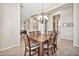 Formal dining room with a large wood table, chandelier, and views into the living room at 1320 W Whitman Dr, Anthem, AZ 85086