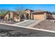 Lovely home showcasing its two car garage and desert landscaping at 1320 W Whitman Dr, Anthem, AZ 85086
