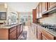 Well-equipped kitchen with wooden cabinetry, stainless steel appliances, and a center island at 1320 W Whitman Dr, Anthem, AZ 85086