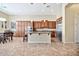 Bright kitchen showcasing wood cabinets, an island with a sink, and stainless steel appliances at 1320 W Whitman Dr, Anthem, AZ 85086