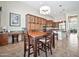 Open kitchen area featuring wooden cabinetry, tile flooring, a central island, and breakfast area with a chandelier at 1320 W Whitman Dr, Anthem, AZ 85086