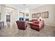 Cozy living room with a fireplace, comfortable seating, and decorative wall art at 1320 W Whitman Dr, Anthem, AZ 85086