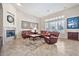 Bright living room featuring a fireplace, comfortable seating, and large window at 1320 W Whitman Dr, Anthem, AZ 85086