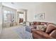 Comfortable living room with natural light, neutral tones, a large sectional, and decorative rug at 1320 W Whitman Dr, Anthem, AZ 85086