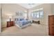 Bright main bedroom with three windows with shutters and a queen size bed at 1320 W Whitman Dr, Anthem, AZ 85086