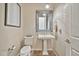 Well-lit powder room featuring a pedestal sink, decorative mirror, and tile flooring at 1320 W Whitman Dr, Anthem, AZ 85086