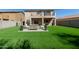 Beautiful backyard with a green lawn and patio seating, perfect for outdoor entertaining at 1329 W Crape Rd, Queen Creek, AZ 85140
