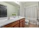Bathroom features a double sink vanity and a shower/tub with a patterned curtain at 1329 W Crape Rd, Queen Creek, AZ 85140
