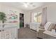 This bedroom has carpet, a crib, and a dresser. The closet has a wide, open doorframe at 1329 W Crape Rd, Queen Creek, AZ 85140