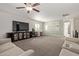 Versatile bonus room featuring a large television, desk, and comfortable sofa at 1329 W Crape Rd, Queen Creek, AZ 85140