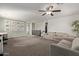 Spacious carpeted bonus room with a ceiling fan and comfortable seating arrangement at 1329 W Crape Rd, Queen Creek, AZ 85140