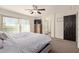 Inviting main bedroom featuring a sliding glass door, ceiling fan, and ensuite bathroom at 1329 W Crape Rd, Queen Creek, AZ 85140