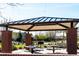 Covered picnic area with tables and a grill, nestled among trees for shaded gatherings at 1329 W Crape Rd, Queen Creek, AZ 85140