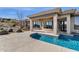 The backyard showcases a beautiful pool, a covered patio, and views of the surrounding desert landscape at 13827 N Sunset Dr, Fountain Hills, AZ 85268