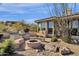 Charming outdoor oasis with custom fire pit, grill, and desert landscaping at 13827 N Sunset Dr, Fountain Hills, AZ 85268