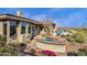 This backyard features a built-in grill, pool, and desert landscaping at 13827 N Sunset Dr, Fountain Hills, AZ 85268