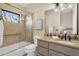 Well-lit bathroom showcasing a glass-enclosed shower and vanity with decorative backsplash at 13827 N Sunset Dr, Fountain Hills, AZ 85268