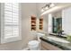 Well-lit bathroom featuring granite countertop, vanity, and shuttered window at 13827 N Sunset Dr, Fountain Hills, AZ 85268