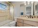 Bathroom with a shower-tub combo, updated fixtures, and natural lighting at 13827 N Sunset Dr, Fountain Hills, AZ 85268