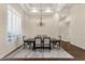 Formal dining room showcasing elegant chandelier, plantation shutters, and ample seating at 13827 N Sunset Dr, Fountain Hills, AZ 85268