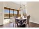 Elegant dining area with a round table, upholstered chairs, chandelier, and large windows overlooking the scenic landscape at 13827 N Sunset Dr, Fountain Hills, AZ 85268