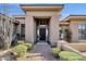 Charming front entry with decorative glass, desert landscaping, and a brick walkway at 13827 N Sunset Dr, Fountain Hills, AZ 85268