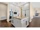 Well-equipped kitchen with stainless steel appliances, a center island, white cabinets, and hardwood floors at 13827 N Sunset Dr, Fountain Hills, AZ 85268