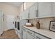 Bright laundry room with white cabinets, counterspace, and modern washer and dryer at 13827 N Sunset Dr, Fountain Hills, AZ 85268