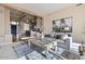 Bright living room featuring a large grey sofa, coffee table, and contemporary art at 13827 N Sunset Dr, Fountain Hills, AZ 85268