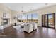Inviting living room featuring a fireplace, comfortable seating, and large windows with expansive views at 13827 N Sunset Dr, Fountain Hills, AZ 85268